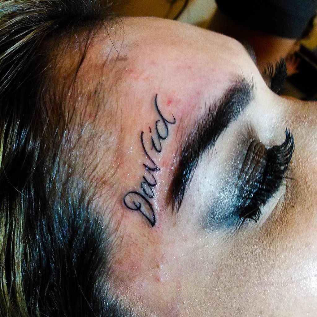 above eyebrow tattoo