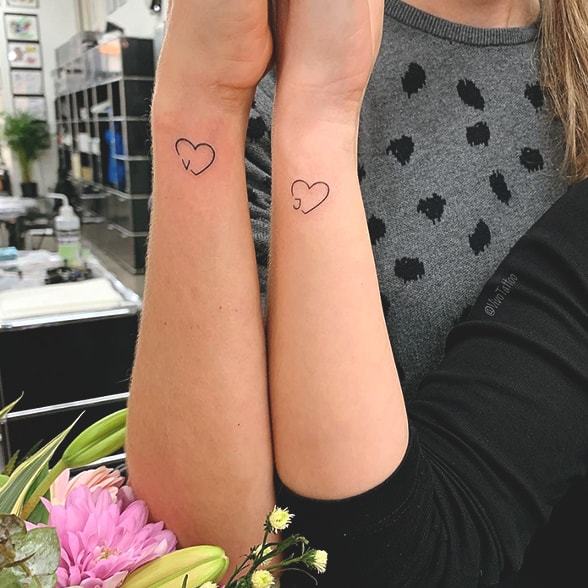 Matching heart tattoos