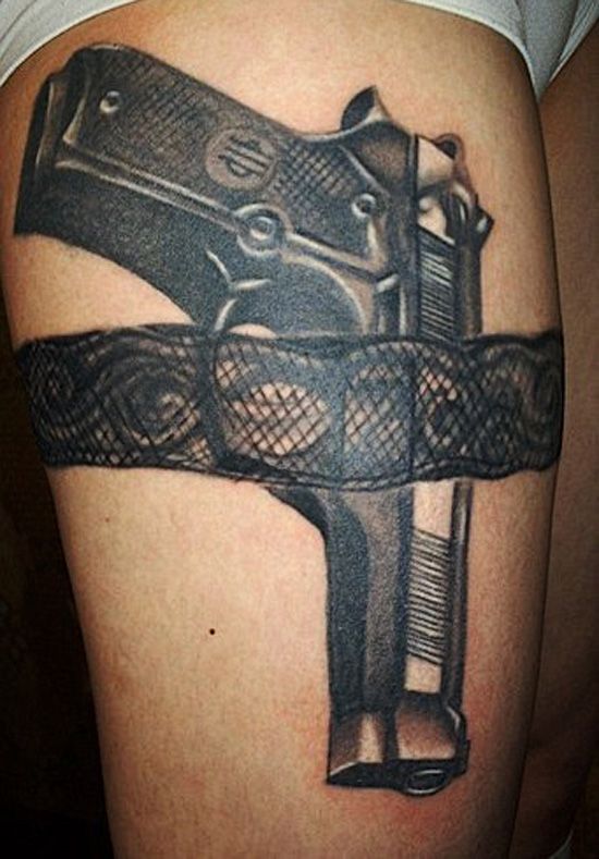 gun tattoo on thigh
