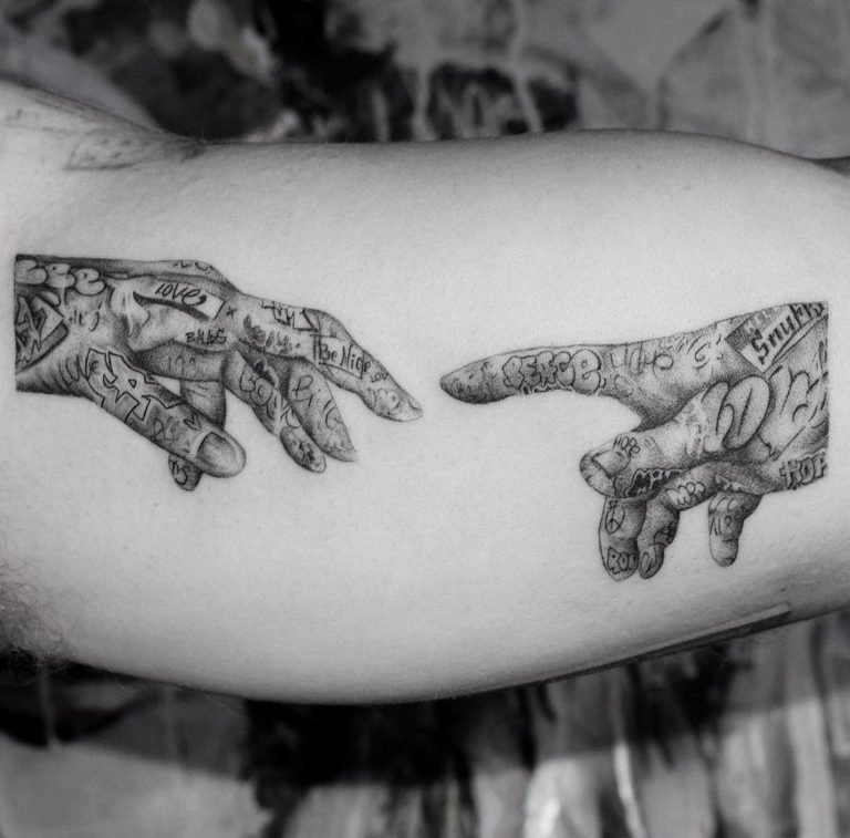 creation of adam hands tattoo