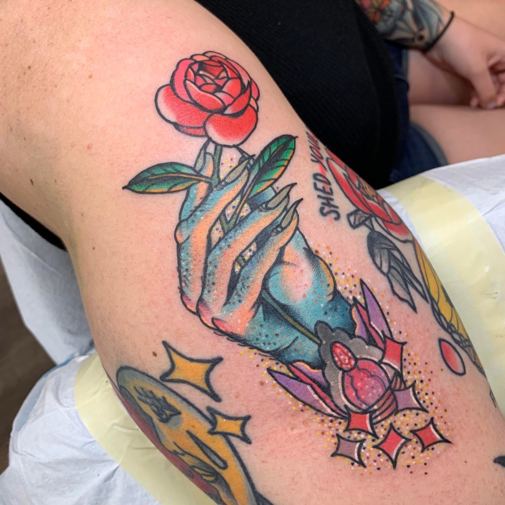 hand holding rose tattoo
