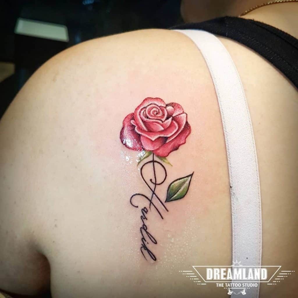 rose tattoo on shoulder with name
