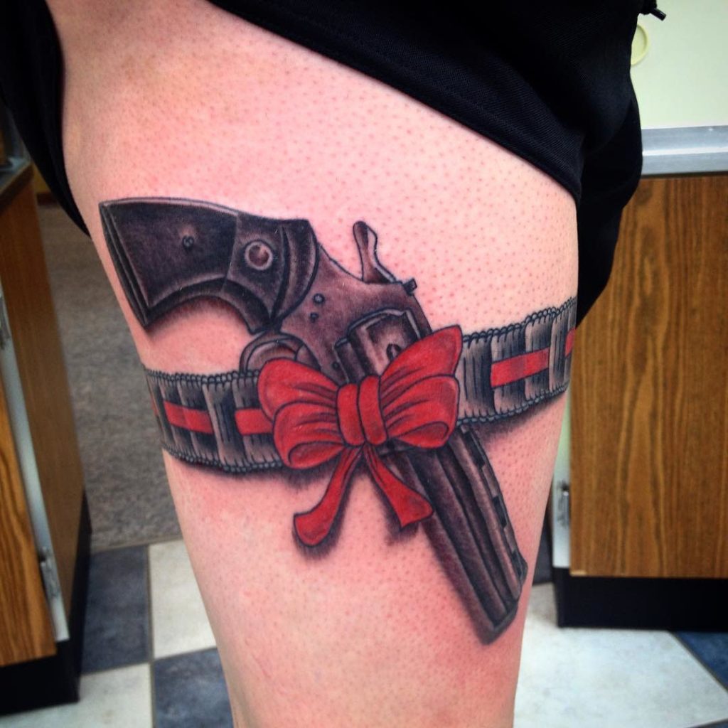 Gun tattoo on hip