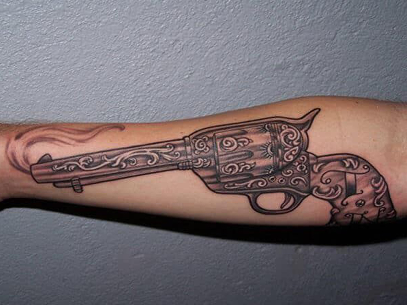 Gun tattoo on hip