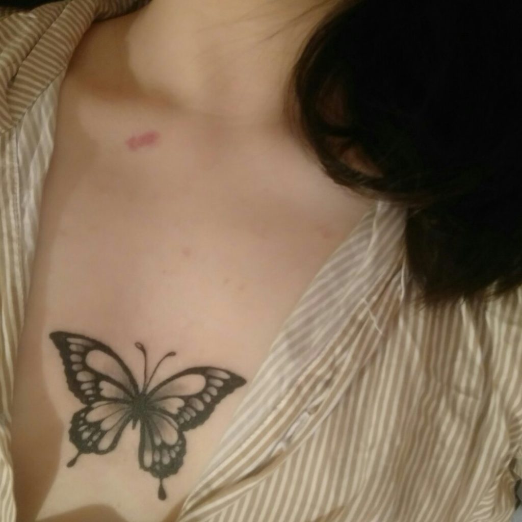 Butterfly tattoo under breast