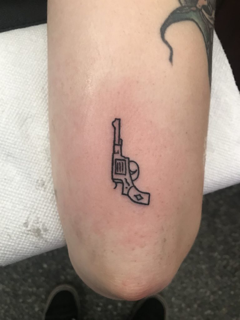 Gun tattoo on hip 