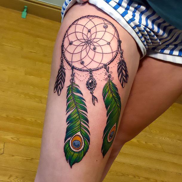 peacock thigh tattoo