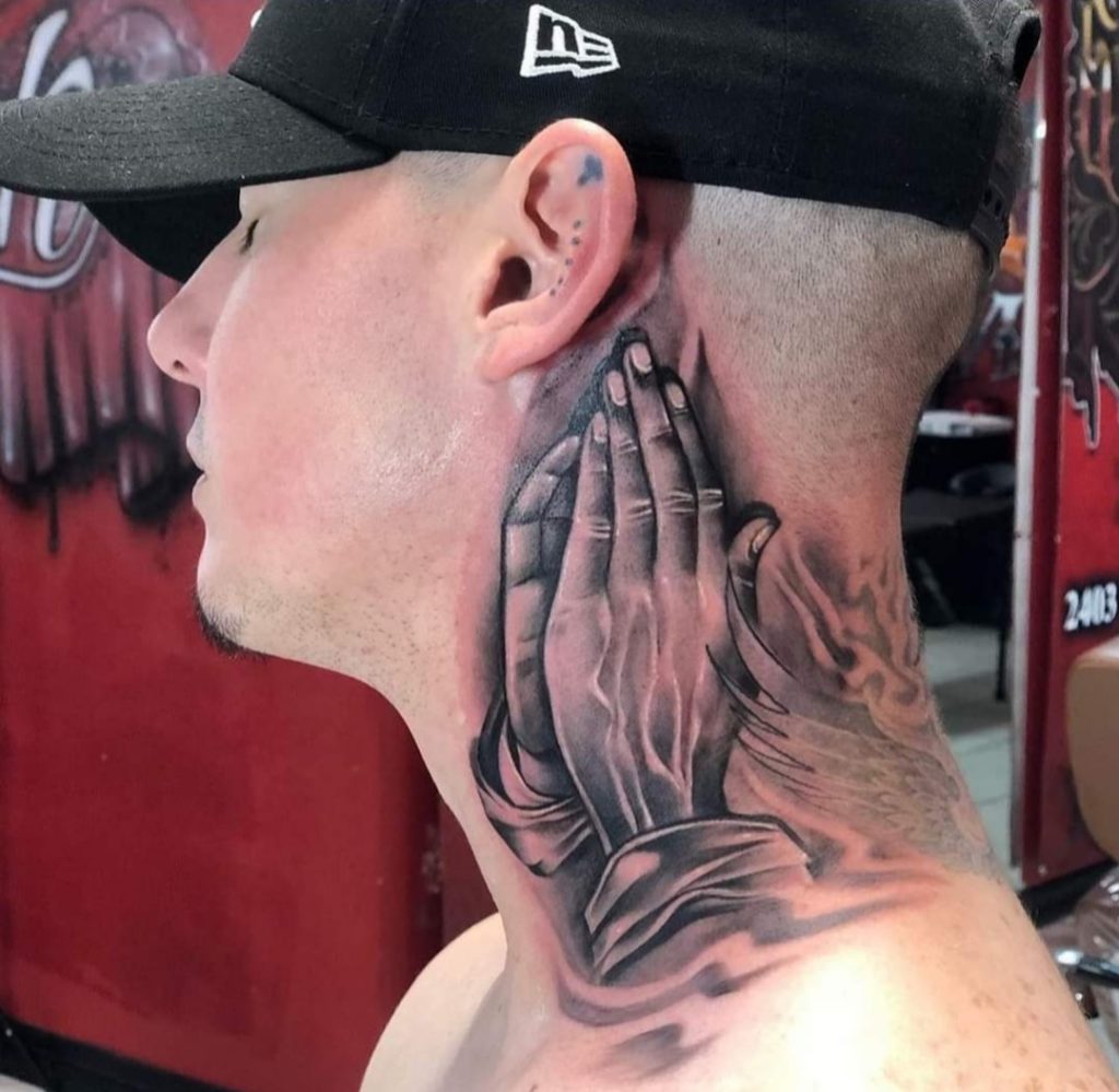 Praying hands neck tattoo