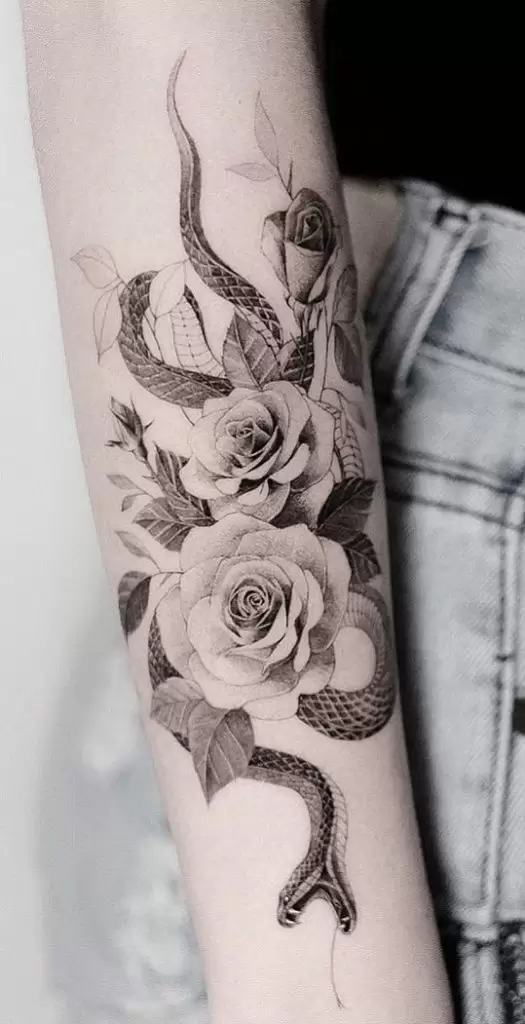 Snake with flowers tattoo