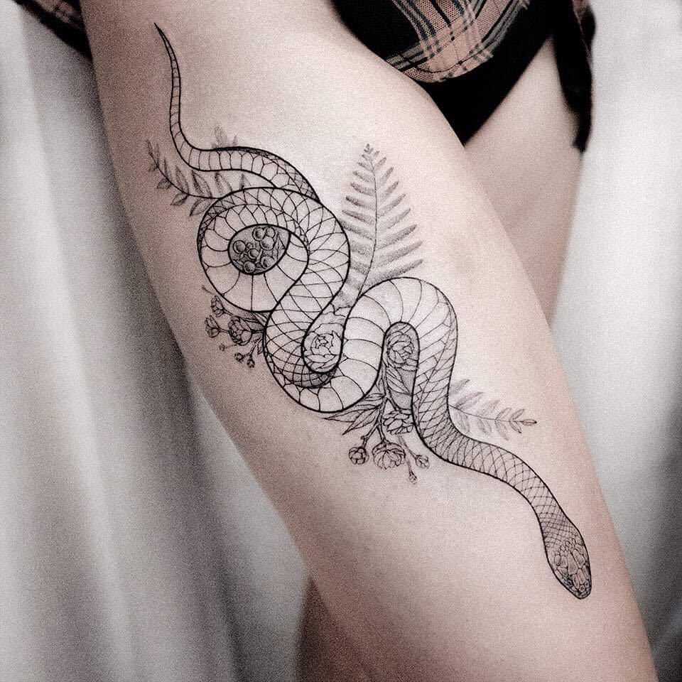 Snake with flowers tattoo