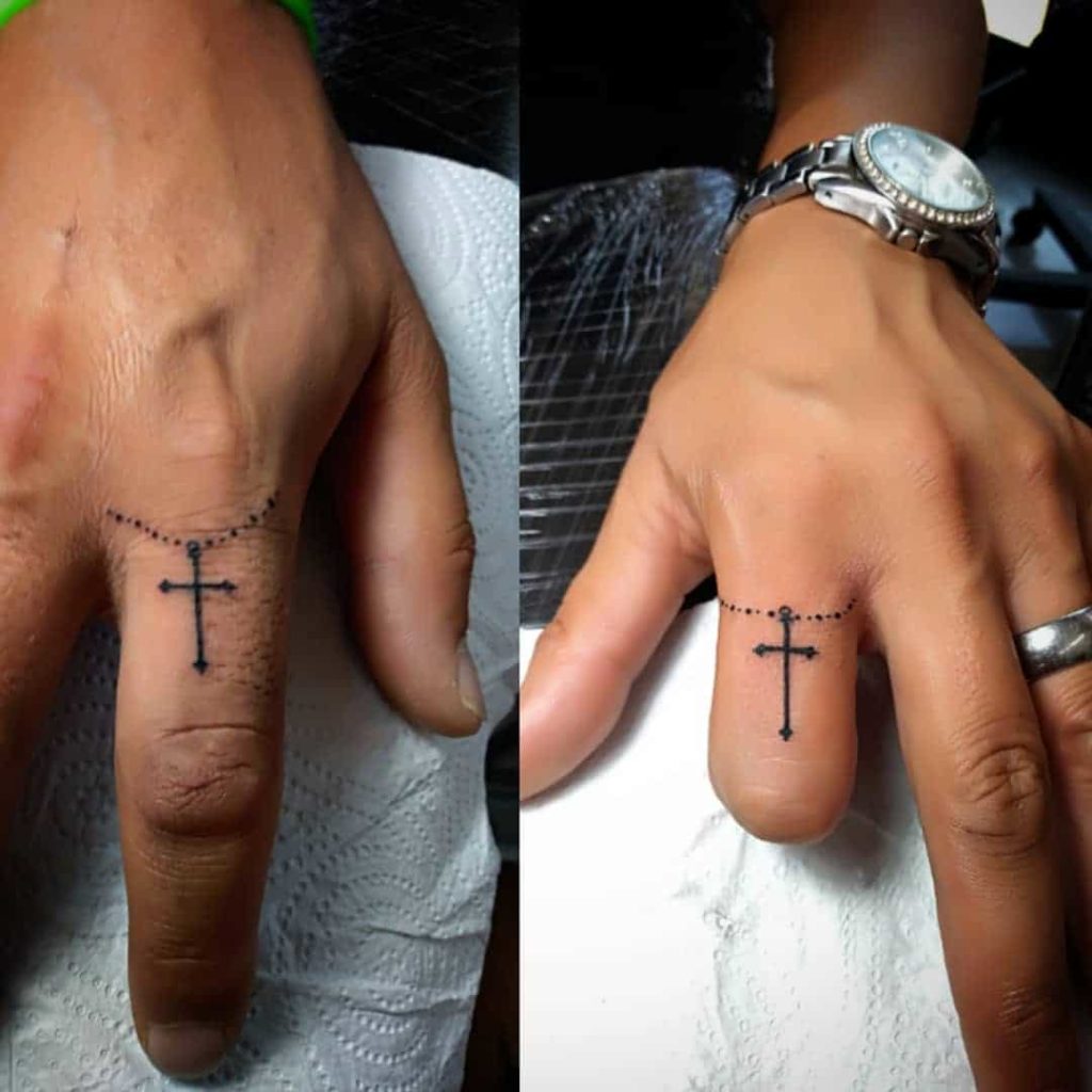 Tiny cross tattoo