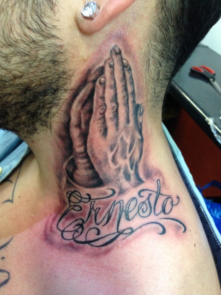 Praying hands neck tattoo