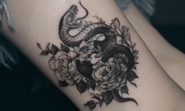 Snake with flowers tattoo 